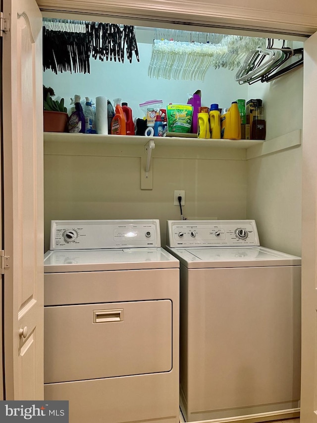 clothes washing area with separate washer and dryer