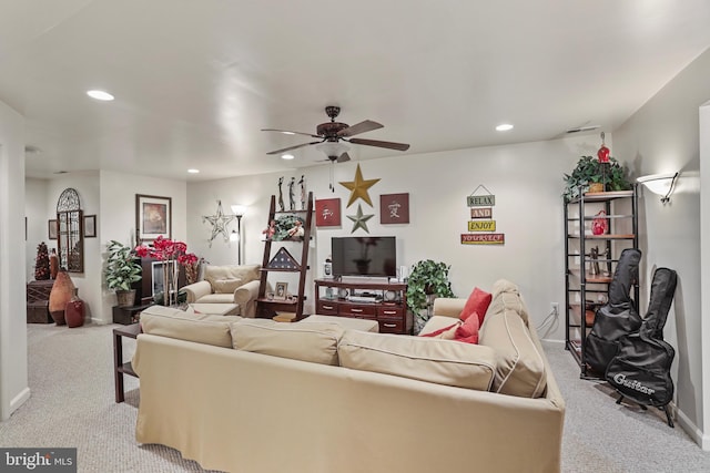 carpeted living room with ceiling fan