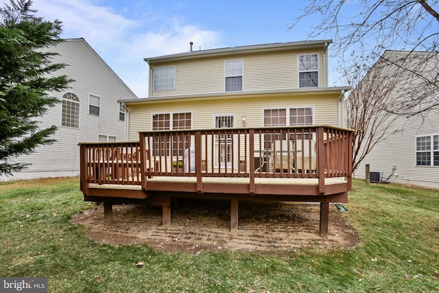 rear view of property with a deck, a lawn, and central air condition unit