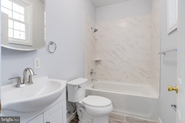 full bathroom with vanity, toilet, and tiled shower / bath