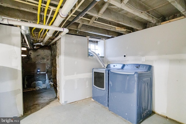 clothes washing area with washing machine and dryer