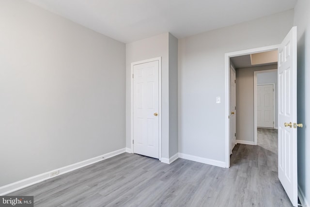 unfurnished bedroom featuring light wood-type flooring