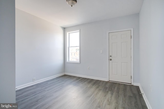 spare room with dark hardwood / wood-style floors