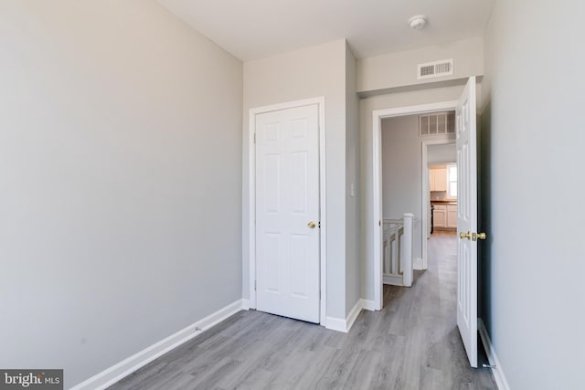 corridor with light wood-type flooring