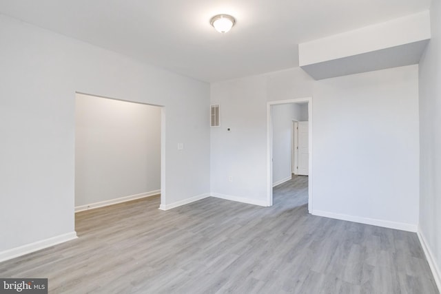 spare room featuring light hardwood / wood-style floors