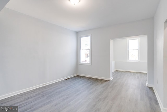 empty room with hardwood / wood-style flooring