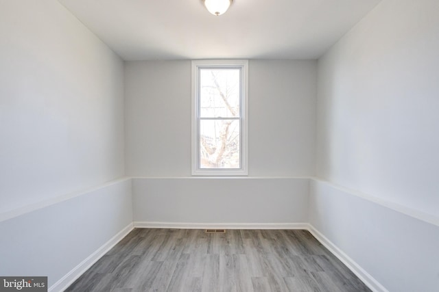 empty room with hardwood / wood-style floors