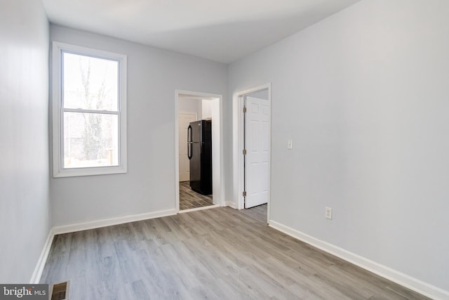 spare room with light hardwood / wood-style flooring