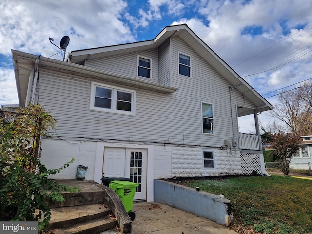 rear view of house featuring a yard