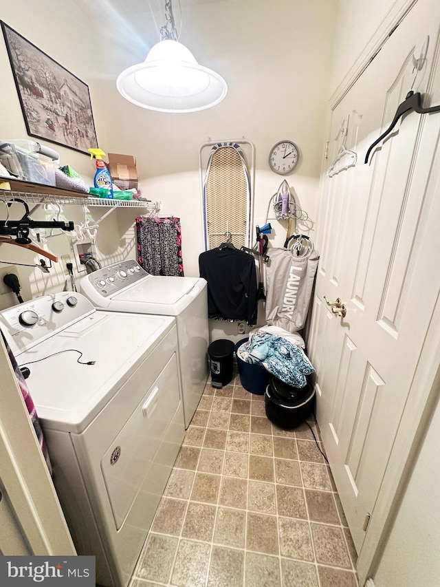 clothes washing area featuring separate washer and dryer