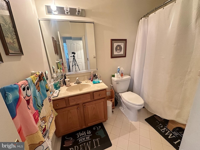 bathroom with tile patterned flooring, vanity, and toilet