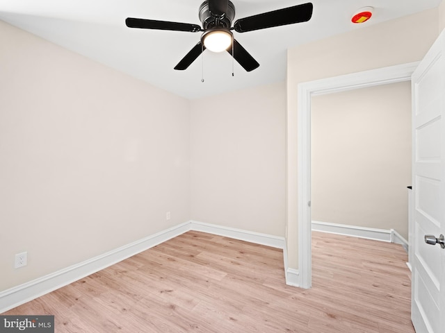 empty room with ceiling fan and light hardwood / wood-style floors