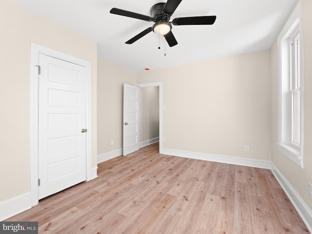 unfurnished bedroom with ceiling fan and light wood-type flooring