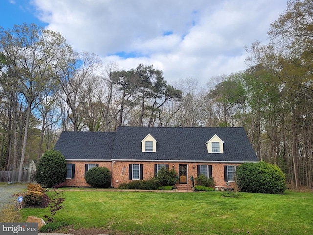 new england style home featuring a front lawn