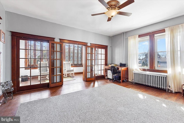 interior space with radiator heating unit, wood-type flooring, and french doors