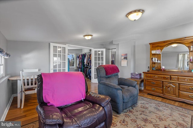 sitting room with hardwood / wood-style floors and french doors