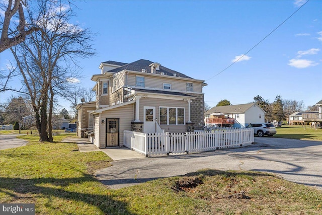 rear view of property with a yard