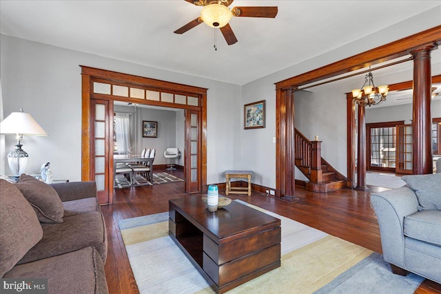 living room with french doors, hardwood / wood-style floors, ceiling fan with notable chandelier, and plenty of natural light