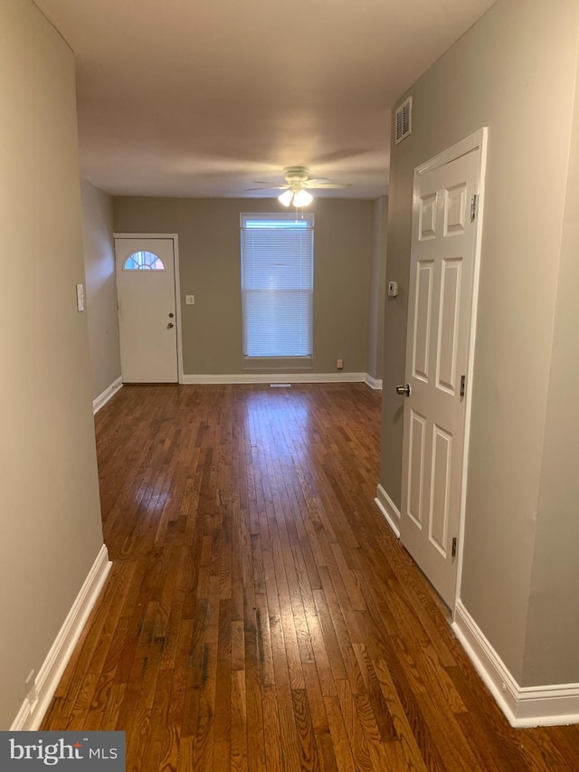 foyer entrance featuring ceiling fan and dark wood-type flooring