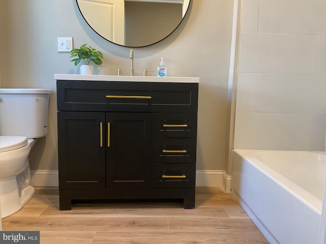 bathroom with hardwood / wood-style floors, vanity, and toilet