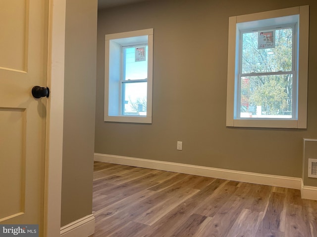 empty room with hardwood / wood-style floors