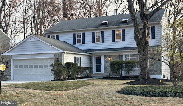 view of front of home with a garage and a front lawn