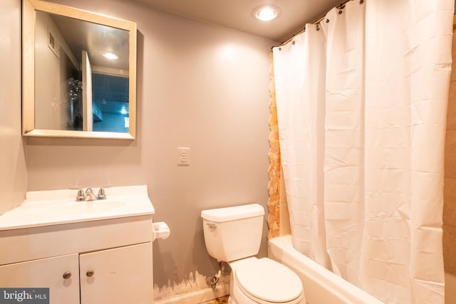 full bathroom featuring vanity, toilet, and shower / bath combo with shower curtain