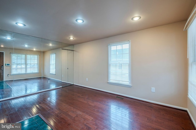 unfurnished room featuring dark hardwood / wood-style floors