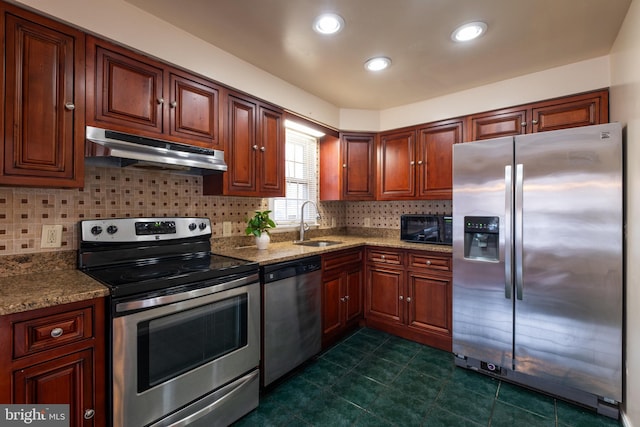 kitchen with backsplash, sink, light stone countertops, and stainless steel appliances