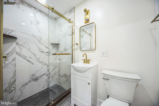 bathroom featuring vanity, toilet, and an enclosed shower