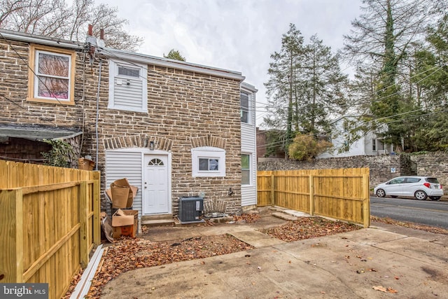 rear view of house featuring central air condition unit and a patio