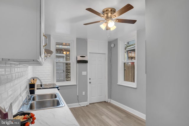 kitchen with plenty of natural light, light hardwood / wood-style floors, sink, and ceiling fan