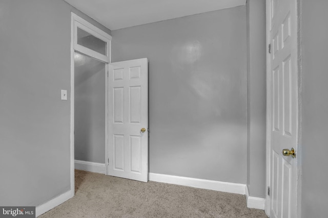 unfurnished room with light colored carpet