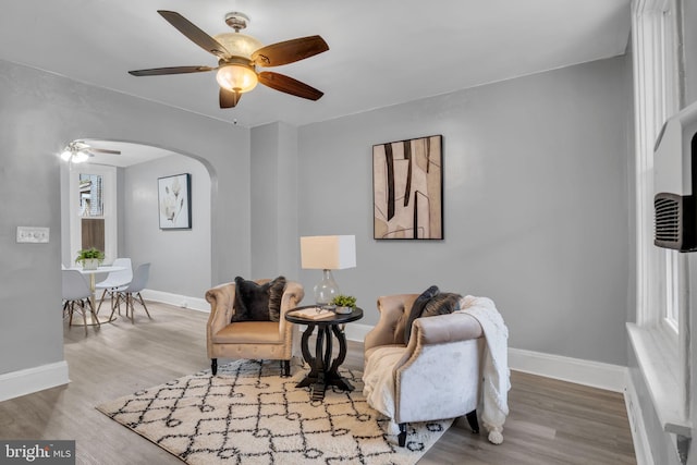 sitting room featuring ceiling fan and light wood-type flooring