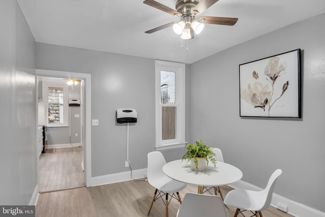 dining area featuring ceiling fan and light wood-type flooring