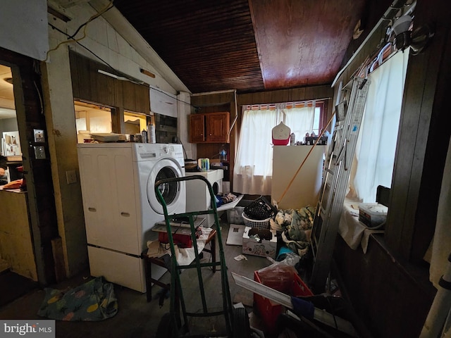 misc room with wood walls and washer / dryer