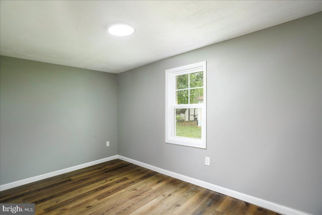 spare room featuring dark hardwood / wood-style flooring