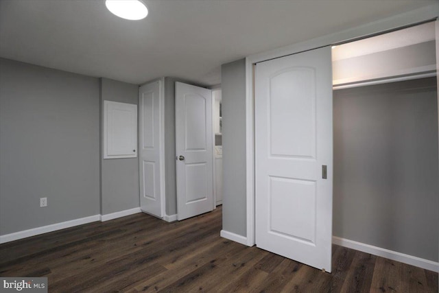 unfurnished bedroom featuring a closet and dark hardwood / wood-style flooring