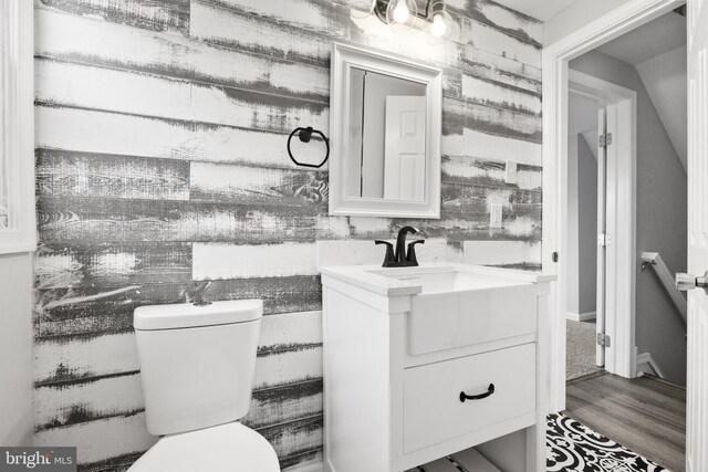 bathroom featuring hardwood / wood-style floors, vanity, and toilet