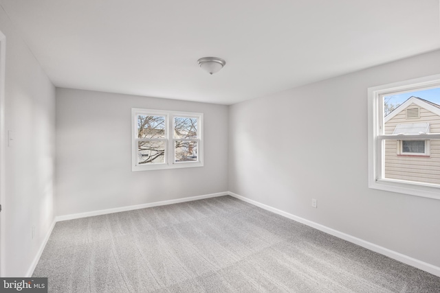 carpeted empty room with a wealth of natural light