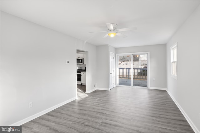 empty room featuring ceiling fan and hardwood / wood-style floors