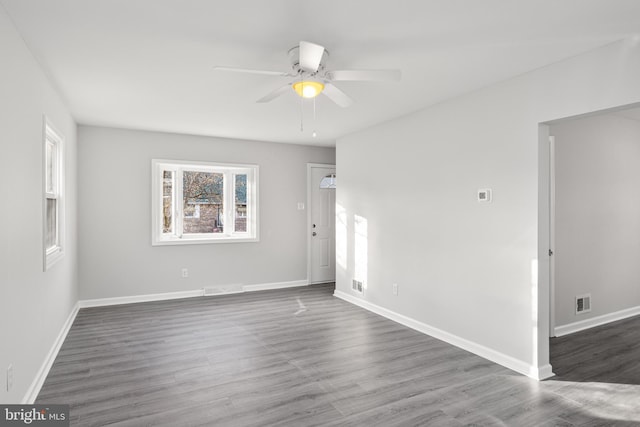 spare room with ceiling fan and dark hardwood / wood-style floors