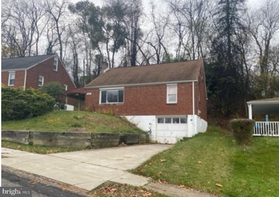 view of side of home with a lawn and a garage