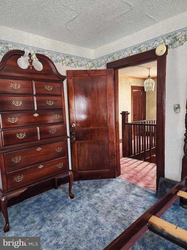 carpeted bedroom with a textured ceiling