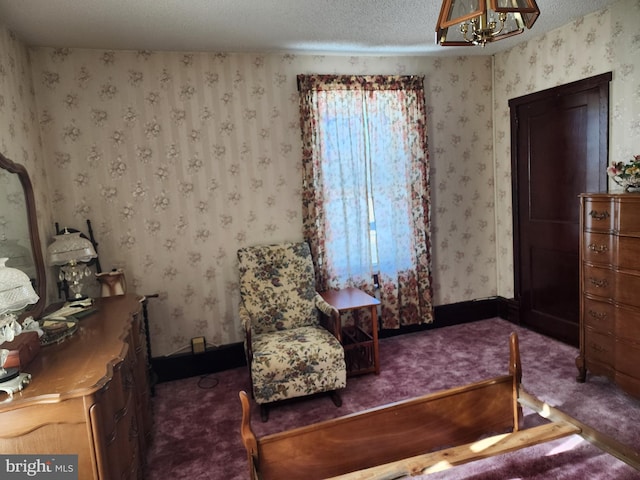 sitting room featuring carpet, a notable chandelier, and a textured ceiling