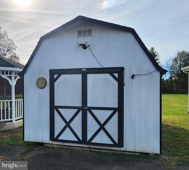 view of outbuilding with a yard