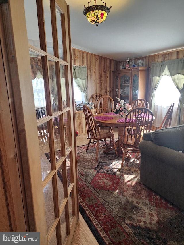 dining room with wood walls and french doors