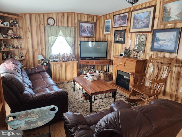 living room featuring built in shelves and wood walls