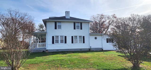 rear view of house with a lawn