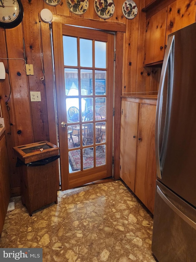 doorway featuring wooden walls